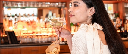lady having a drink at the bar